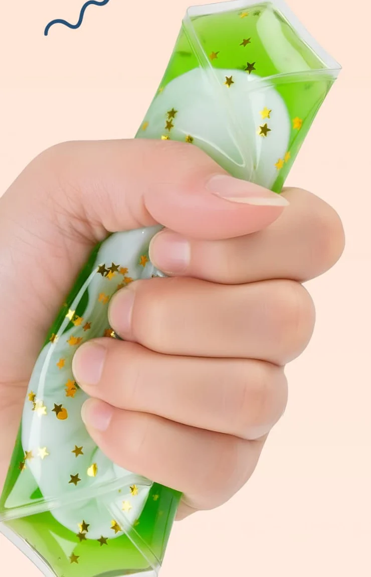 A hand squeezing a Jumble Comb liquid motion tile